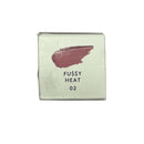 Cosmetic compact with pink shade and 'Fussy Heat 02' text on a light green background
