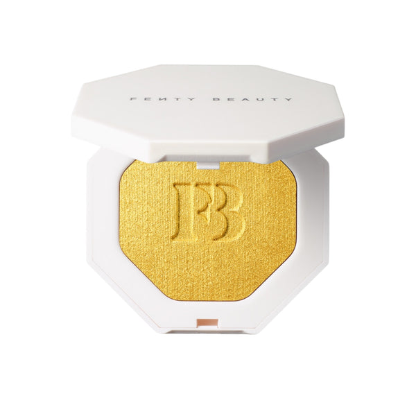 Fenty Beauty product with gold shade and white packaging on a white background