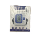 Digital blood pressure monitor in packaging on a white background