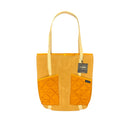 Yellow tote bag with quilted orange sections on a white background