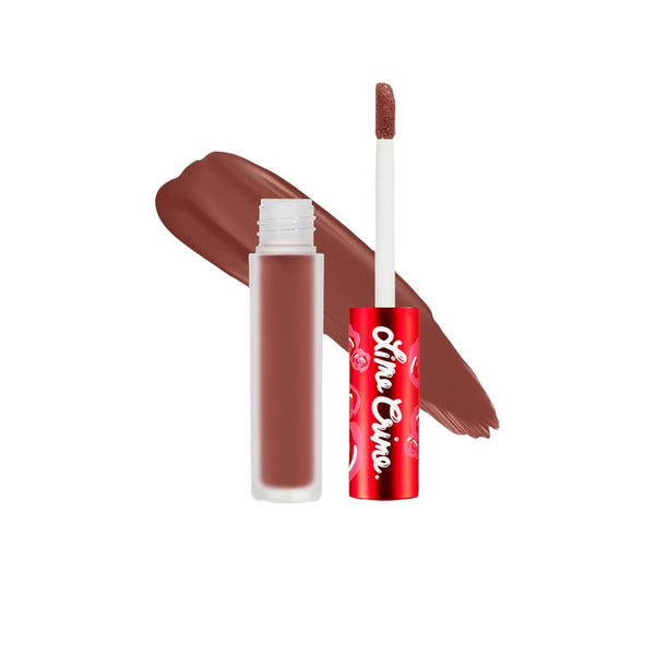 Lip gloss with applicator and swatch on a white background