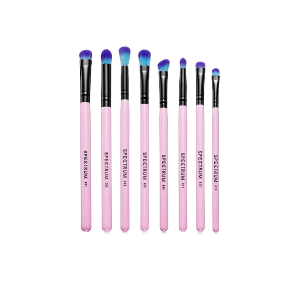 Set of pink makeup brushes with black handles on a white background