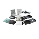 Collection of vinyl records and packaging on a white background